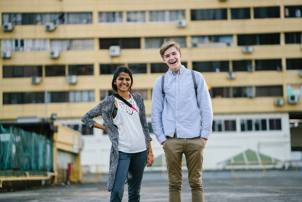 Portrait of a young attractive tourist couple standing in the daytime. The female is indian and male caucasian.They are both dressed casually  - Foto, immagini