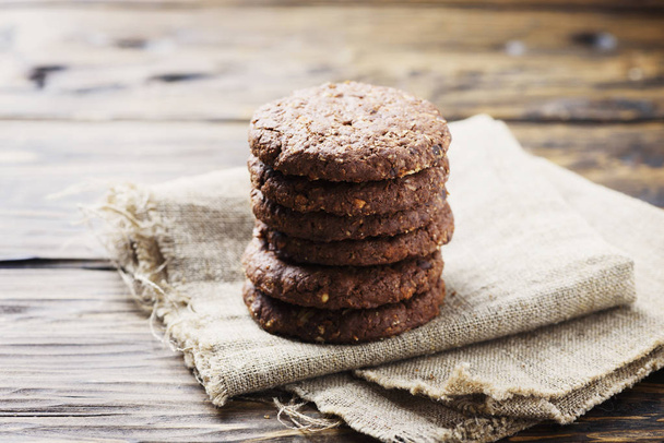 Stack of chocolate cookies on wooden table - Foto, imagen
