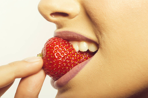 female lips eating red strawberry - Photo, Image