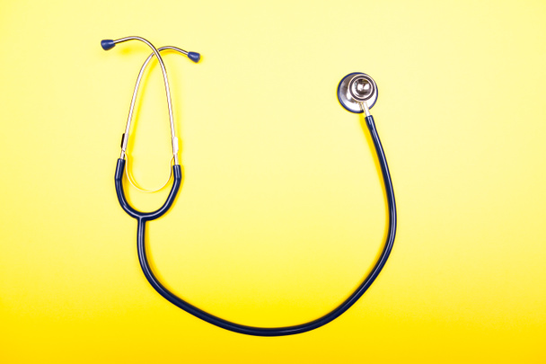 Medical stethoscope on yellow background in studio photo. Top vi - Photo, Image
