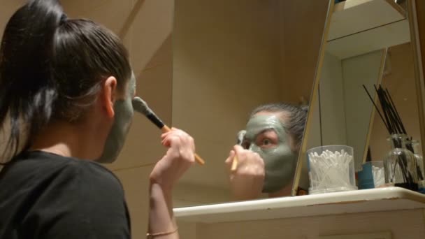 Girl causes Clay mask on face - Footage, Video