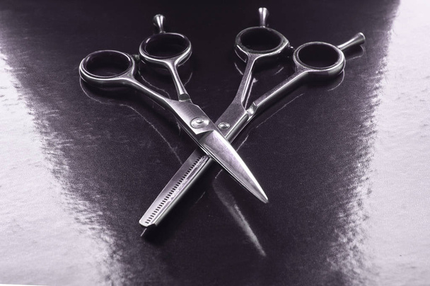 Stylish Professional Barber Scissors, Hair Cutting on black background. Hairdresser salon concept, Hairdressing Set. Haircut accessories. Copy space image, flat lay - Photo, Image