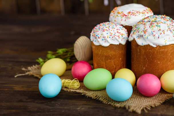 Easter cake and colorful eggs on a wooden table. It can be used as a background - Φωτογραφία, εικόνα
