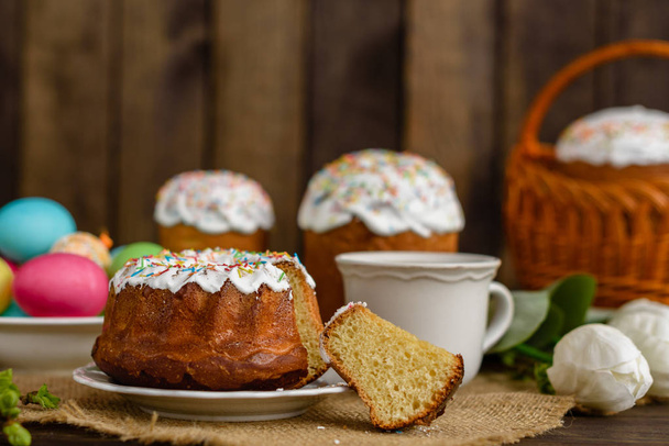 Easter cake and colorful eggs on a wooden table. It can be used as a background - Fotografie, Obrázek