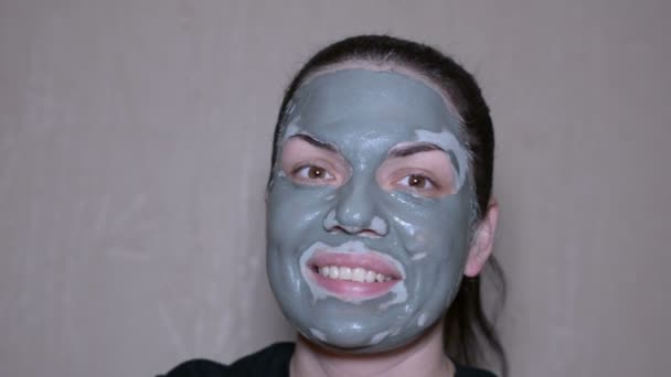 Girl with a clay mask on emotional face - Footage, Video