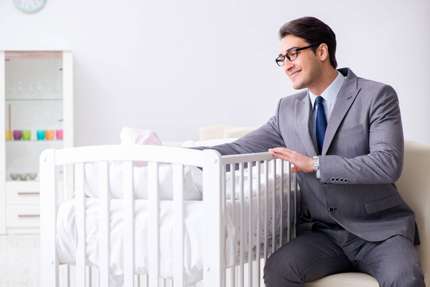 Young businessman trying to work from home caring after newborn  - Foto, Imagem