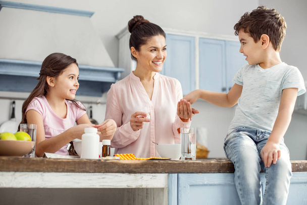 Delighted mother having breakfast with her children - Photo, Image