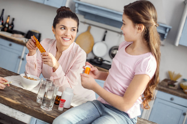 Joyful mother talking about vitamins with her dear girl - Photo, image