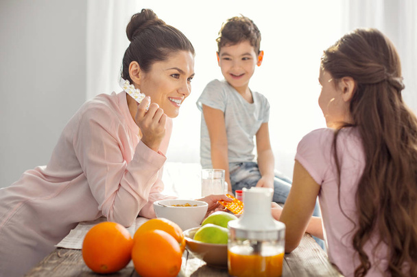 Happy mom telling her kids about vitamins - 写真・画像