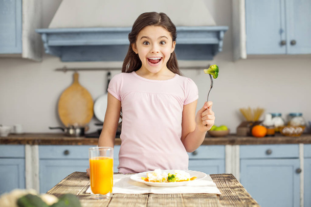 Delighted girl and having healthy breakfast - Foto, Bild