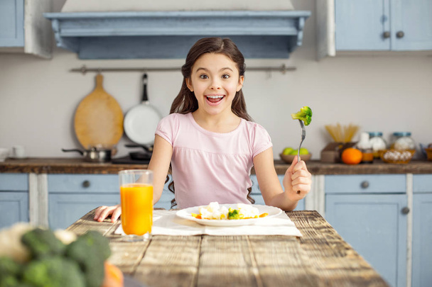 Glad girl and having healthy breakfast - Фото, зображення