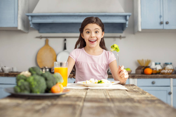 Smiling girl and having healthy breakfast - Фото, зображення