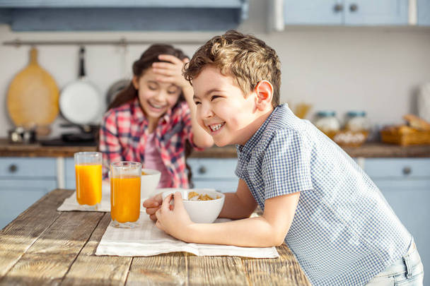 Happy little boy having breakfast with his sister - Foto, Imagen