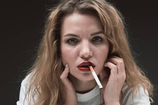 Pensive lady abusing nicotine product - Foto, Imagen