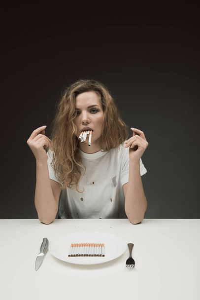 Sad female smoker eating nicotine - Photo, image