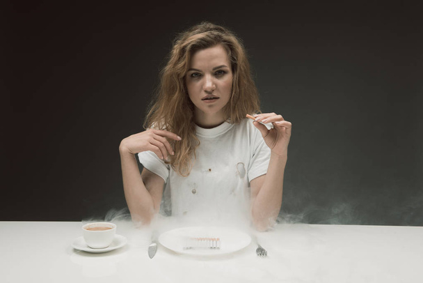 Tranquil girl having bad habit of smoking - Фото, зображення