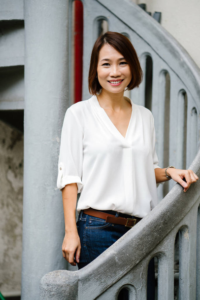 Portrait of a middle-aged and attractive Chinese Asian woman  in smart casual (white shirt) - Fotoğraf, Görsel