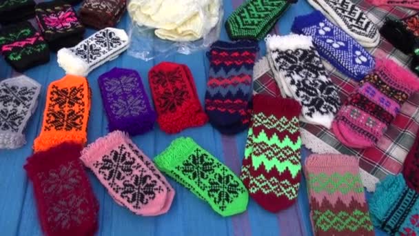 Assorted handmade knitted mittens collection in fair - Footage, Video