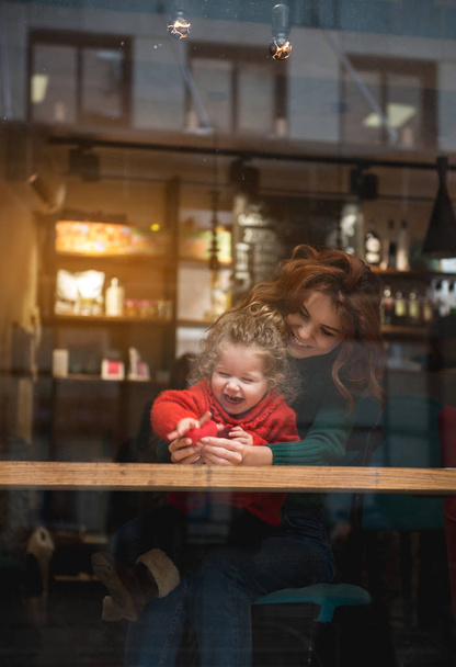 Happy woman hugging her little daughter indoors - Fotoğraf, Görsel