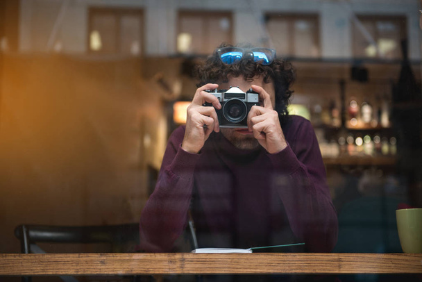 Serious male photographer taking photos indoors - Valokuva, kuva