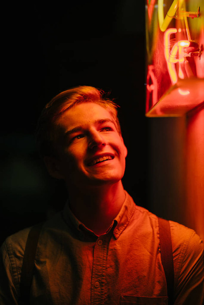 young  Caucasian man at the night market during the Chinese New Year festival in Asia.  tourist  smiling and having fun. - Photo, Image