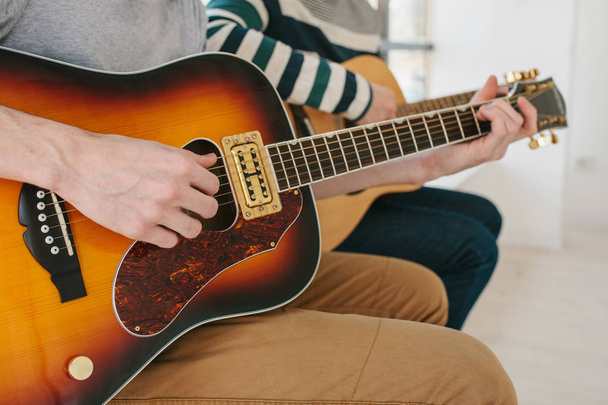 Learning to play the guitar. Music education and extracurricular lessons. Hobbies and enthusiasm for playing guitar and singing songs. - Photo, image