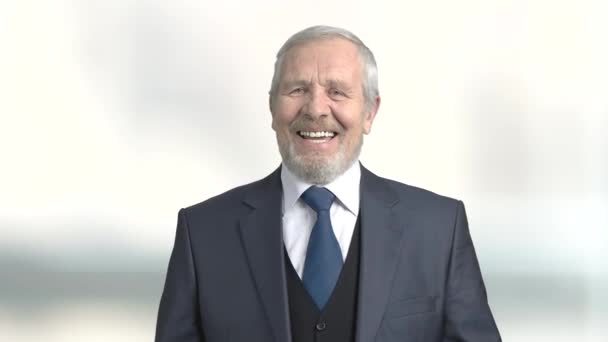 Joyful senior businessman, blurred background. - Footage, Video