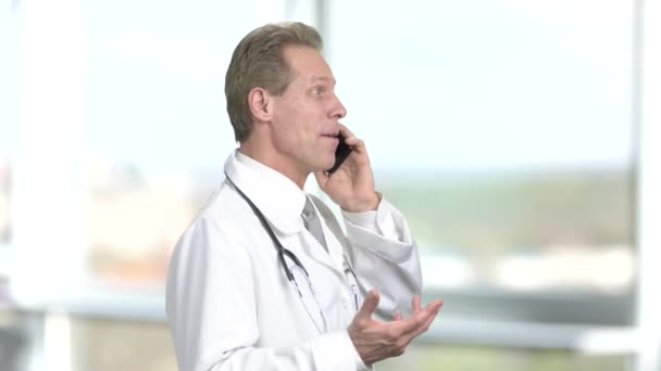 Cheerful medical doctor talking on phone. - 映像、動画