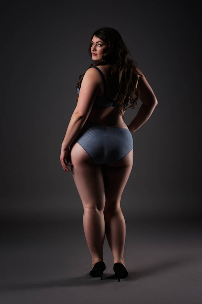 Plus size sexy model in underwear, fat woman on gray background, overweight female body - Foto, Imagen