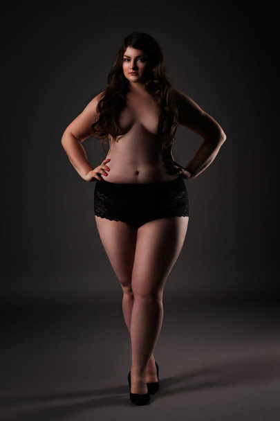 Plus size sexy model in underwear, fat woman on gray background, overweight female body - 写真・画像