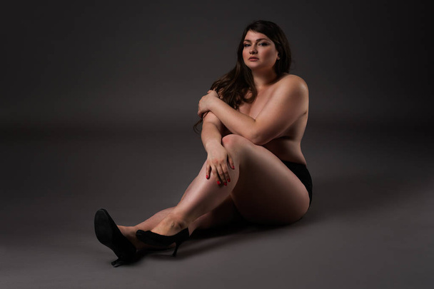Plus size sexy model in underwear, fat woman on gray background, overweight female body - Foto, imagen