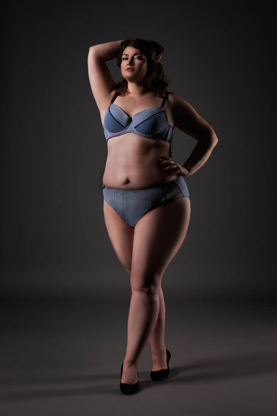 Plus size sexy model in underwear, fat woman on gray background, overweight female body - Foto, afbeelding