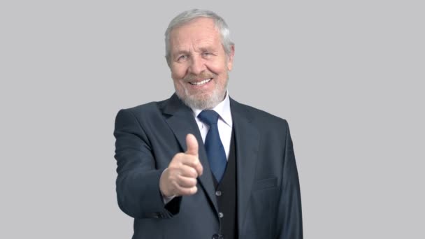 Handsome old businessman gesturing thumb up. - Footage, Video