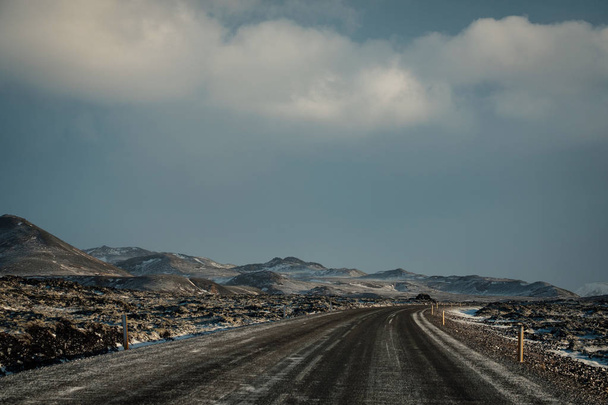 Driving in icelandic winter. Blowing snow across the road. Difficult driving conditions in winter season in Iceland. Sunny but windy day, typical Icelandic route troubles. Icelandic safety driving. - 写真・画像