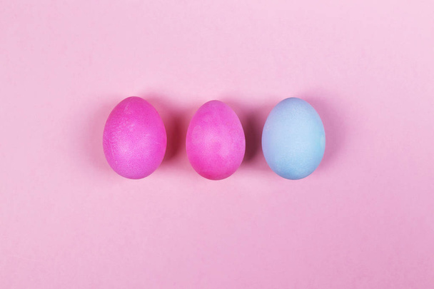 Pink and blue eggs on pink background. Top view - Fotografie, Obrázek