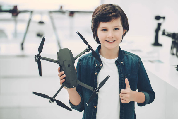 Boy in quadcopter store - Photo, Image