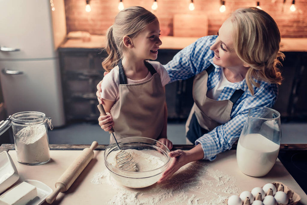 Grandmother and granddaughter cooking on kitchen - 写真・画像