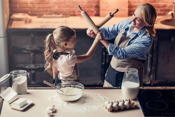 Grandmother and granddaughter cooking on kitchen - Фото, зображення