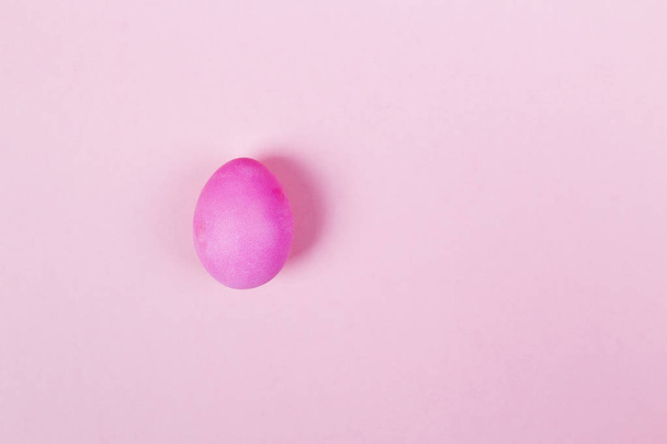 Pink egg on pink background. Top view, copy space - Foto, imagen