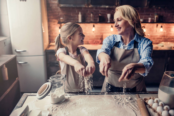 Grandmother and granddaughter cooking on kitchen - Foto, Imagen