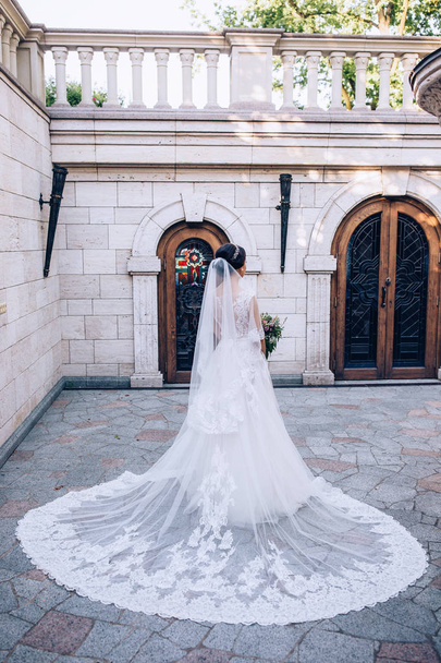 Наречена в білій сукні тримає красивий весільний букет
. - Фото, зображення