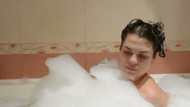 The girl is bathed in a tub with foam - Footage, Video
