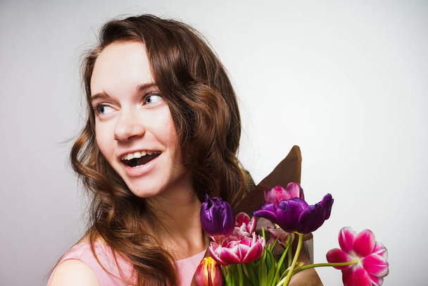happy beautiful young woman celebrating a world women's day, gave a bouquet of flowers - Zdjęcie, obraz