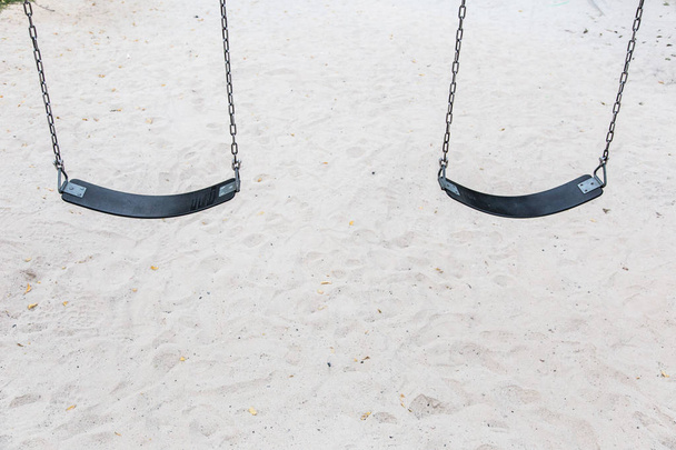pair of swings against the background of sand - Φωτογραφία, εικόνα