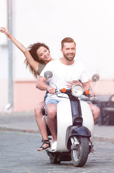 Cool man and beautiful girl riding on  scooter with  expression - Fotografie, Obrázek