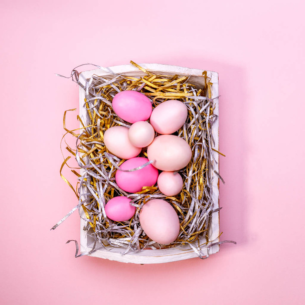 Αυγά σε έναν άσπρο δίσκο. Δημιουργική ιδέα Πάσχα. Σύγχρονη στερεά ροζ - Φωτογραφία, εικόνα