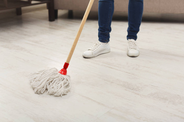 Unrecognizable woman with mop ready to clean floor - Fotoğraf, Görsel