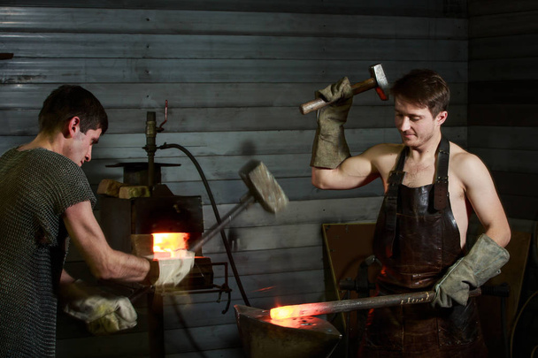 the blacksmith is at the forge - Photo, image
