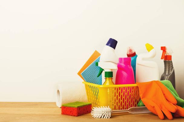 Bucket with cleaning items on table - Φωτογραφία, εικόνα