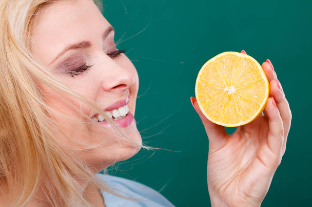 Girl holding lemon citrus fruit - 写真・画像